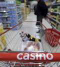 A customer stands in an aisle near a shopping trolley in a Casino supermarket in Nice