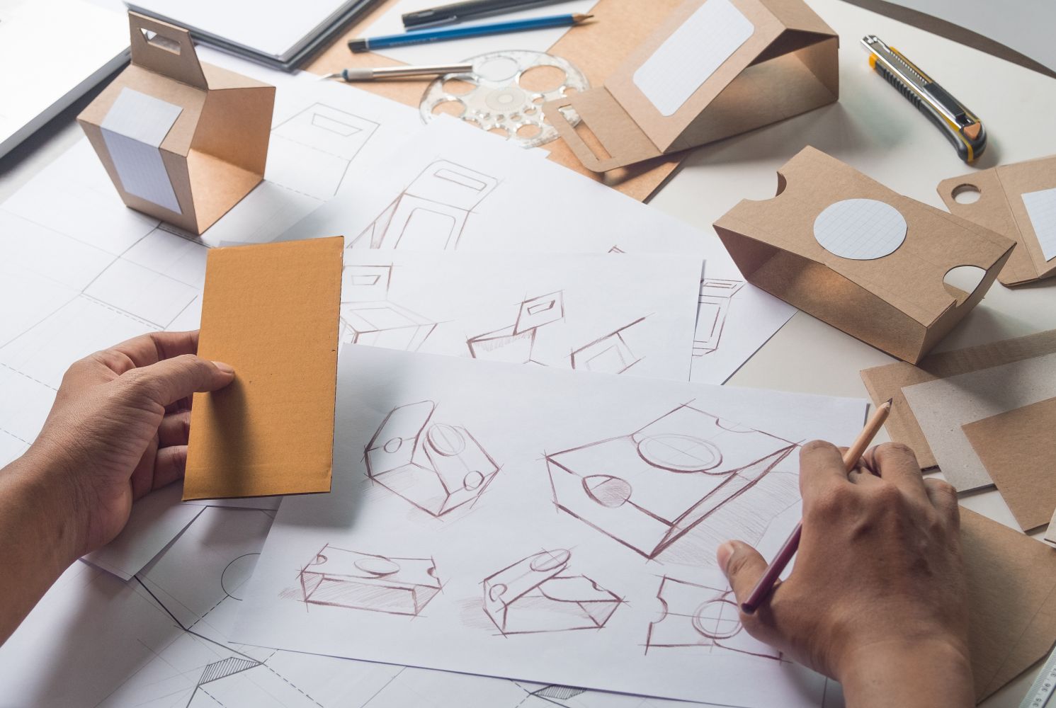 Designer sketching drawing design Brown craft cardboard paper pr
